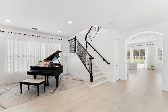 miscellaneous room with ornamental molding and light hardwood / wood-style floors