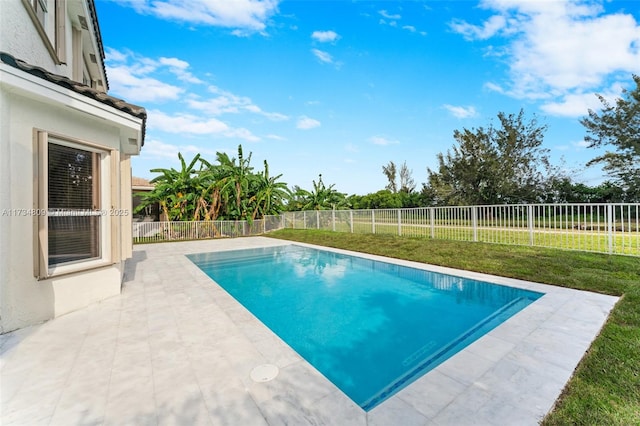 view of pool with a yard, a fenced in pool, a fenced backyard, and a patio