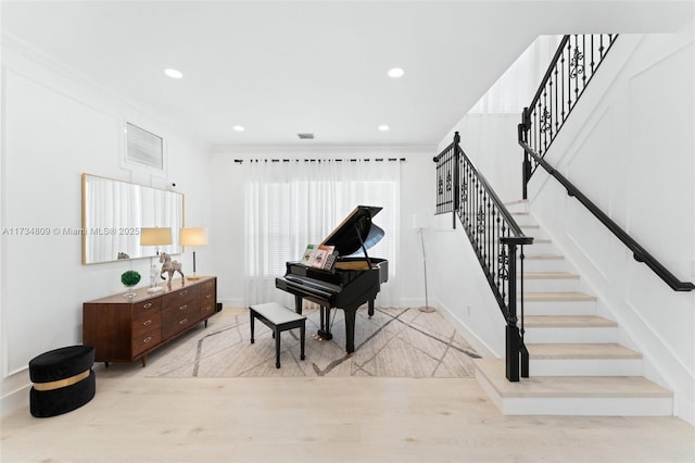 sitting room featuring stairway, ornamental molding, wood finished floors, and recessed lighting