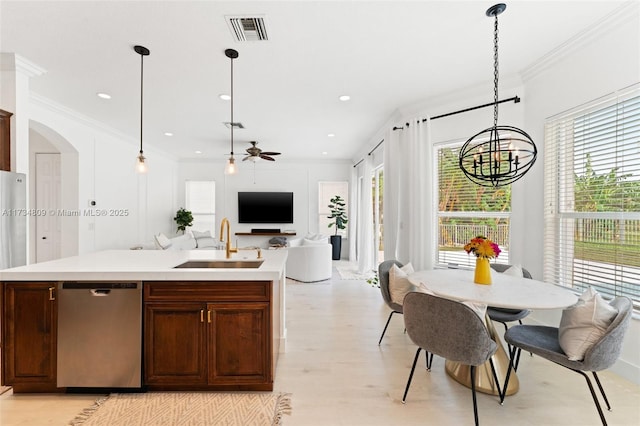 kitchen featuring arched walkways, visible vents, ornamental molding, a sink, and dishwasher