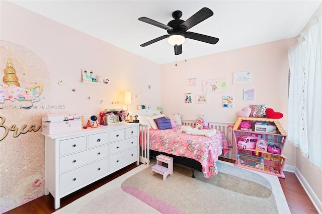 bedroom with dark wood-style floors, ceiling fan, and baseboards