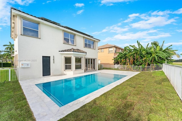 back of property featuring a patio area, a fenced backyard, stucco siding, and a yard