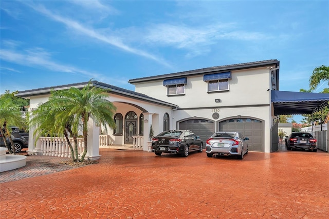 mediterranean / spanish-style home with a garage and covered porch