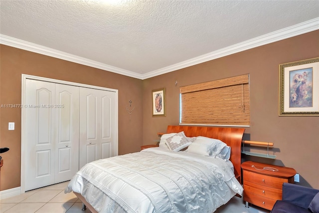 tiled bedroom with ornamental molding, a textured ceiling, and a closet