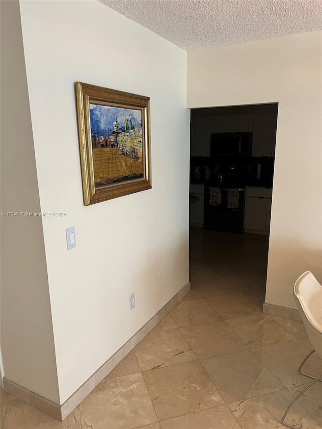 hall with a textured ceiling