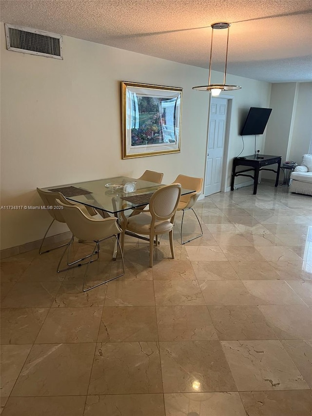 dining area with a textured ceiling