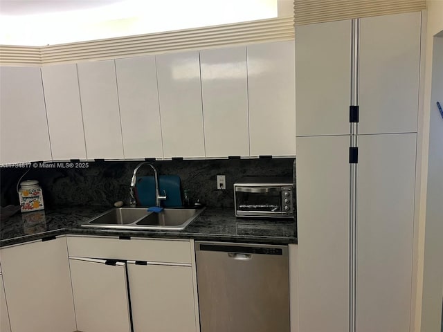 kitchen featuring sink, white cabinetry, tasteful backsplash, refrigerator, and stainless steel dishwasher