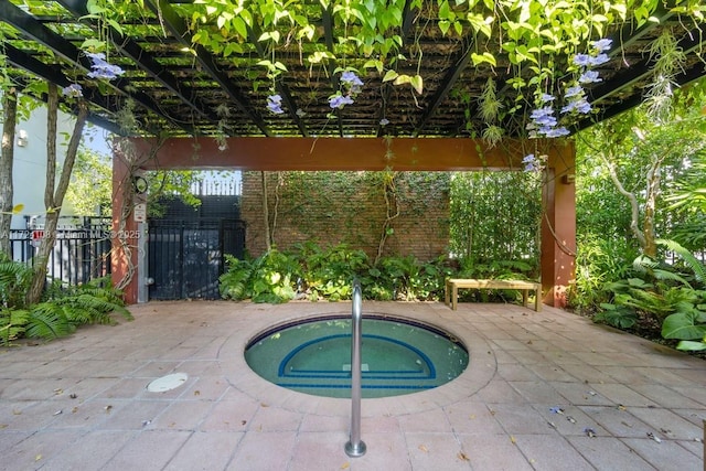 view of swimming pool featuring an in ground hot tub and a patio