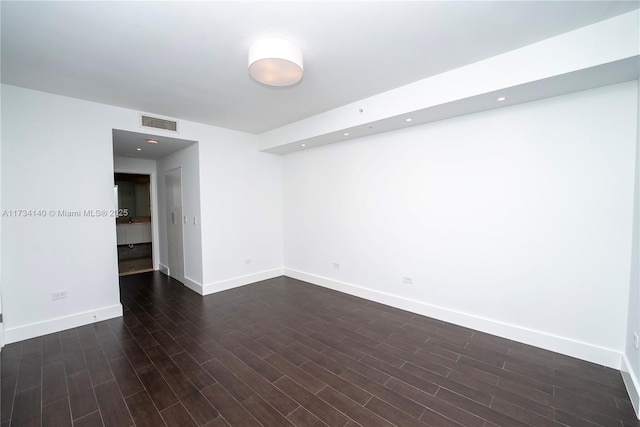 empty room with dark hardwood / wood-style floors