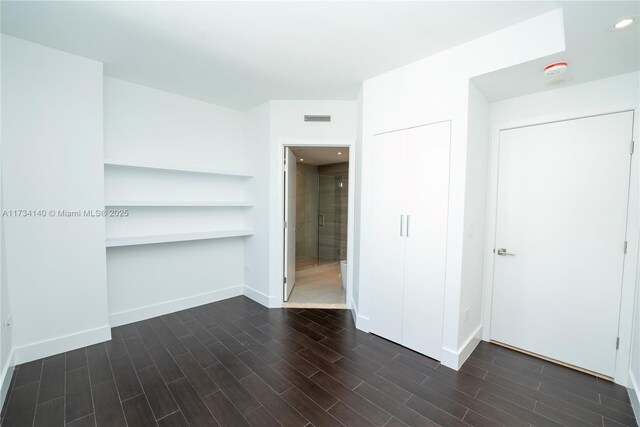 empty room featuring dark wood-type flooring