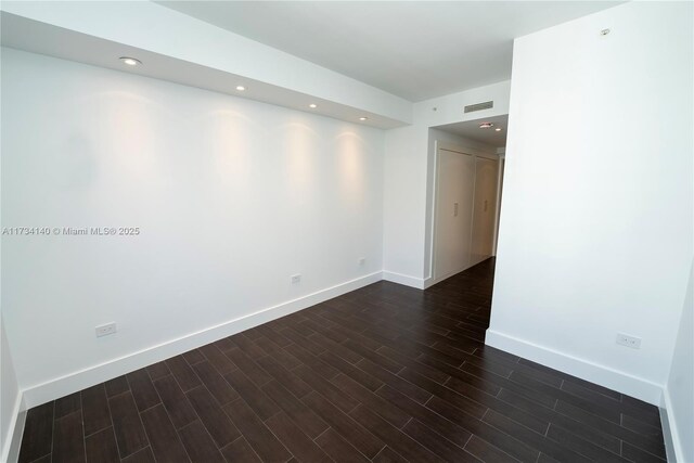 spare room featuring dark hardwood / wood-style floors