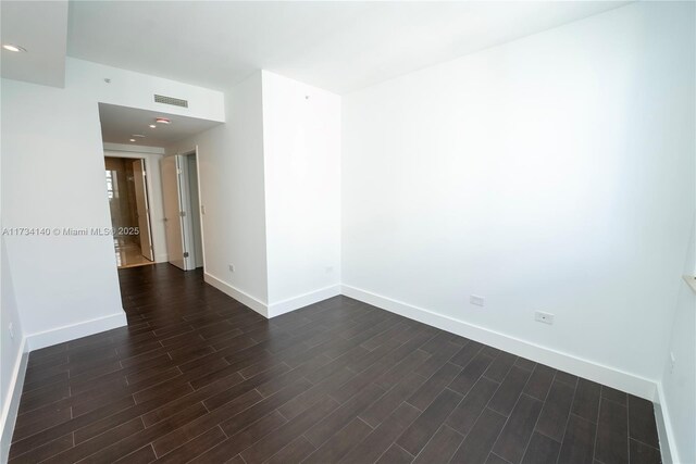 unfurnished room featuring dark hardwood / wood-style flooring