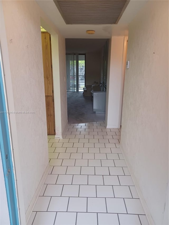 hallway featuring light tile patterned flooring