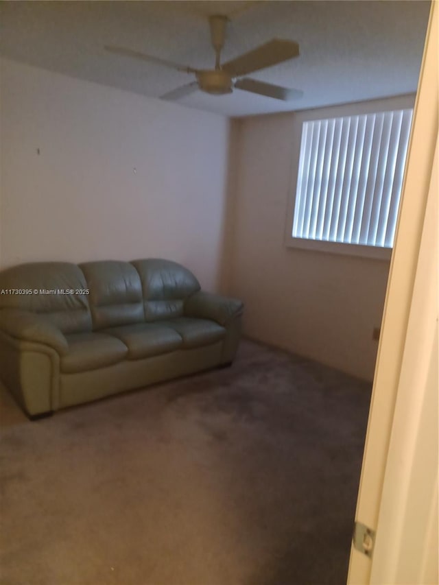 living room with carpet floors and ceiling fan