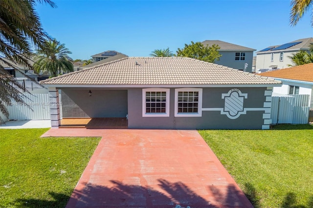 back of property featuring a yard and a patio area