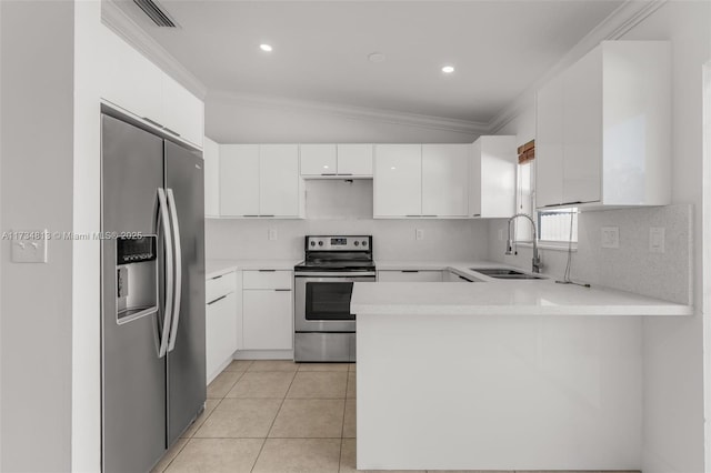 kitchen with sink, light tile patterned floors, white cabinetry, stainless steel appliances, and kitchen peninsula