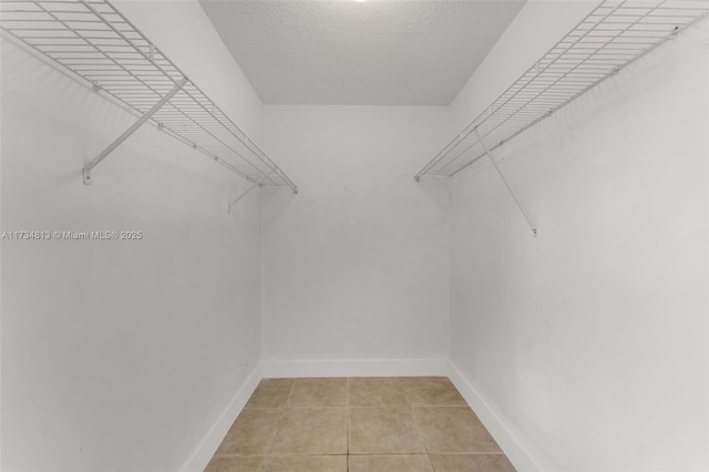 walk in closet featuring light tile patterned flooring