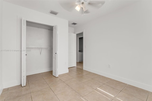 unfurnished bedroom featuring light tile patterned floors, ceiling fan, and a closet