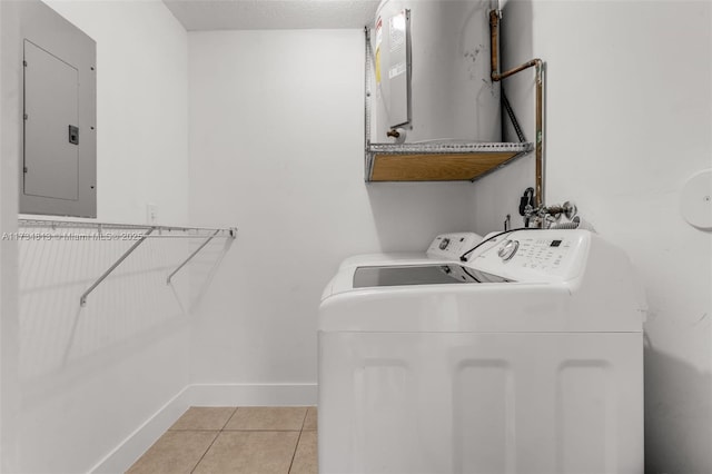 laundry area with light tile patterned flooring, separate washer and dryer, electric panel, and a textured ceiling