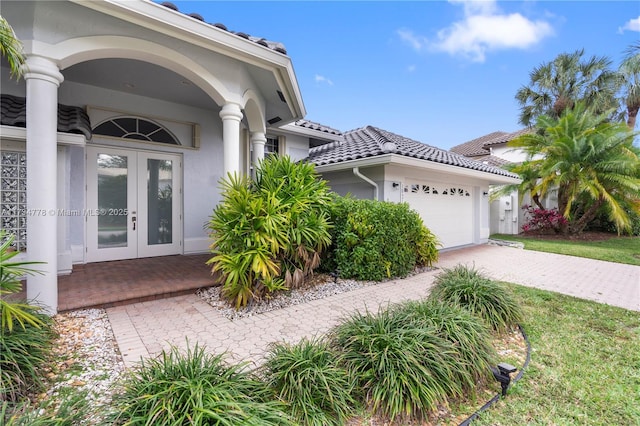 view of front of house featuring a garage and french doors