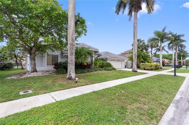 view of front of house with a garage and a front lawn