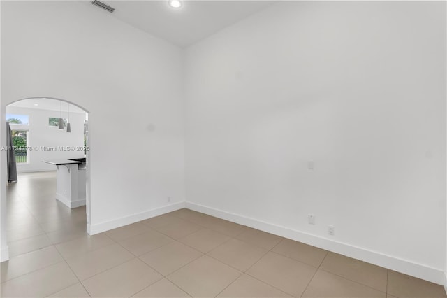 spare room featuring light tile patterned flooring