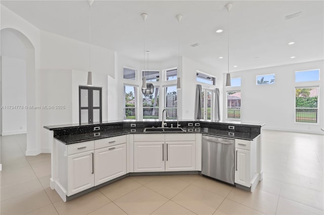 kitchen with a kitchen island with sink, sink, stainless steel dishwasher, and white cabinets