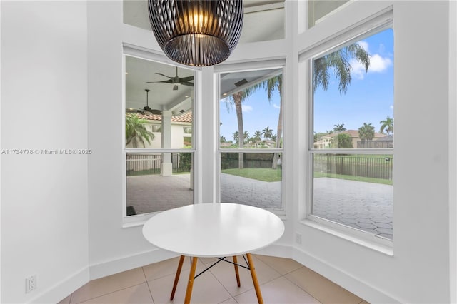 sunroom featuring ceiling fan