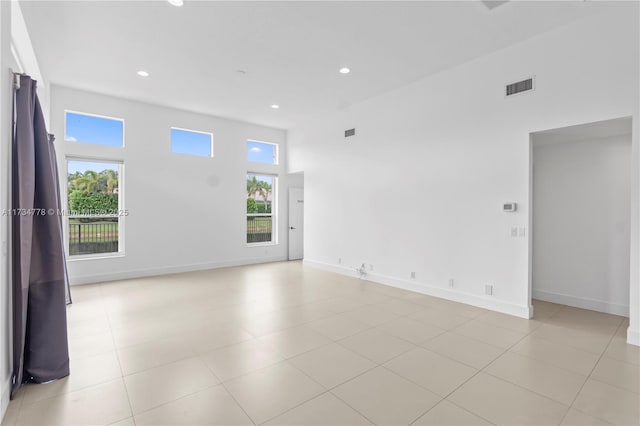 spare room featuring a towering ceiling