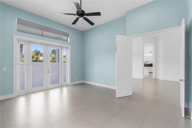 empty room featuring french doors and ceiling fan