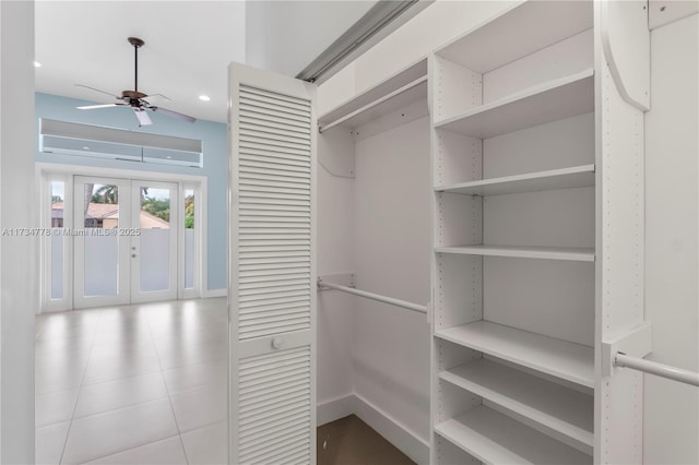 walk in closet featuring french doors and ceiling fan