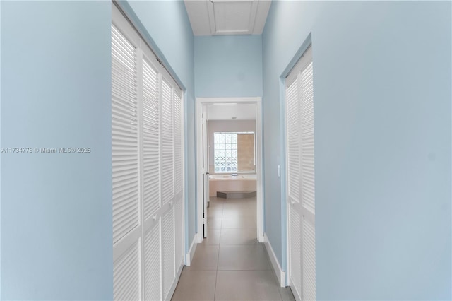 hall featuring light tile patterned flooring