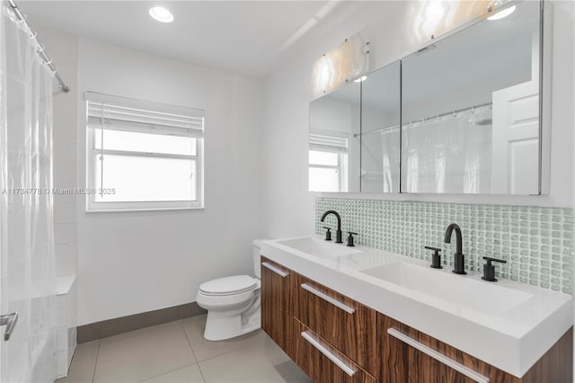 bathroom featuring vanity, backsplash, tile patterned floors, and toilet