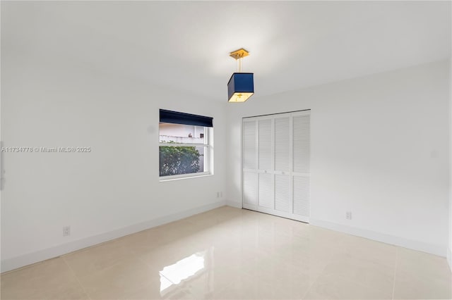 unfurnished bedroom featuring tile patterned floors and a closet