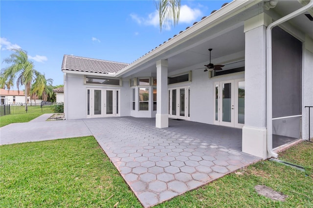 back of property featuring a patio, a yard, ceiling fan, and french doors