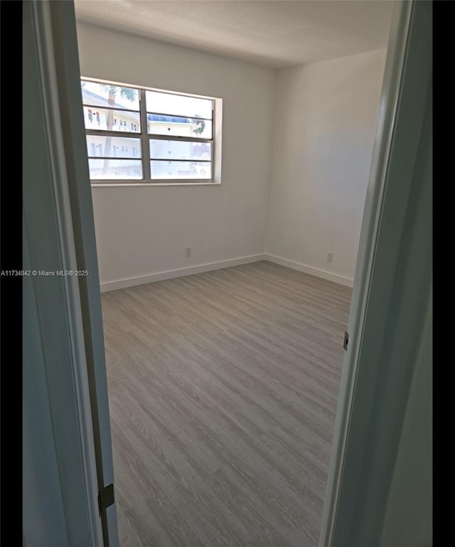 spare room featuring light hardwood / wood-style flooring