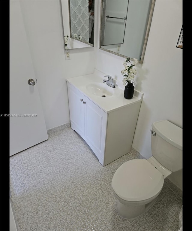 bathroom with tile patterned floors, vanity, and toilet