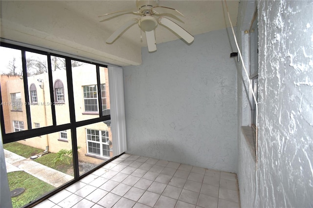 unfurnished sunroom with ceiling fan