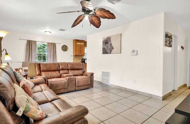 living room with ceiling fan and light tile patterned flooring