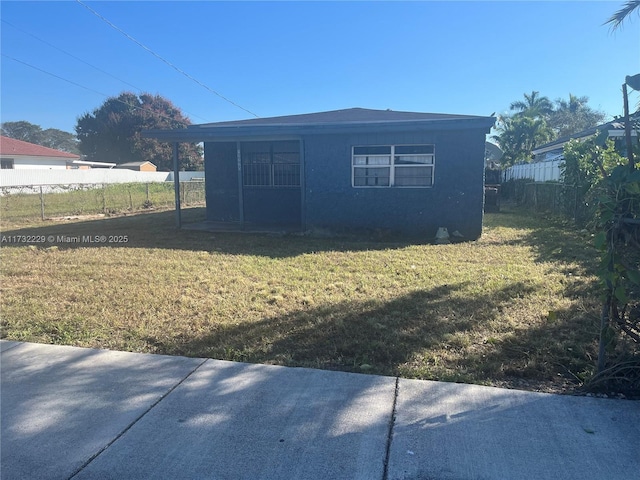 view of side of home featuring a yard