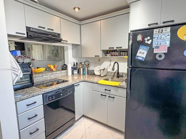 kitchen with sink, crown molding, light stone counters, black appliances, and exhaust hood