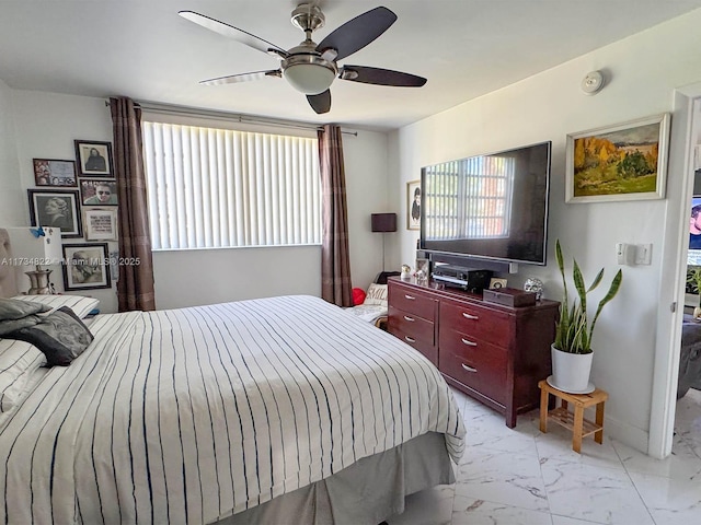 bedroom featuring ceiling fan and multiple windows