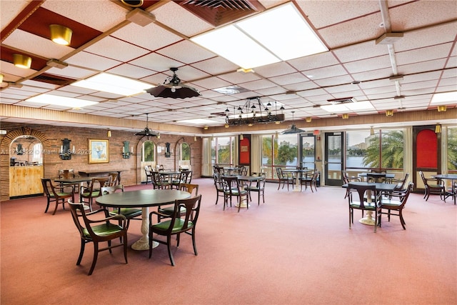 carpeted dining area with ceiling fan and a wealth of natural light