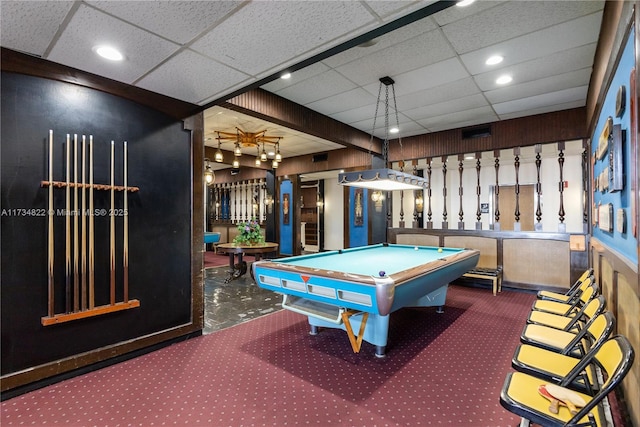 game room with pool table, a paneled ceiling, and dark colored carpet