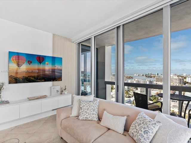 living room featuring expansive windows, plenty of natural light, and light tile patterned floors