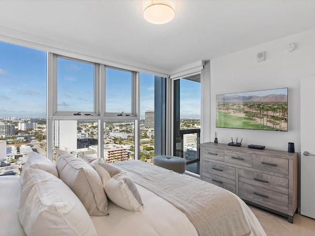 tiled bedroom featuring a wall of windows and access to outside