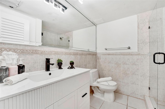 bathroom featuring tile walls, tile patterned flooring, an enclosed shower, vanity, and toilet