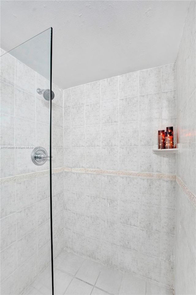 bathroom with tiled shower