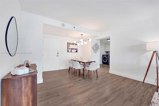 dining space with dark wood-type flooring and washer / clothes dryer