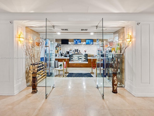 interior space featuring ornamental molding and pendant lighting